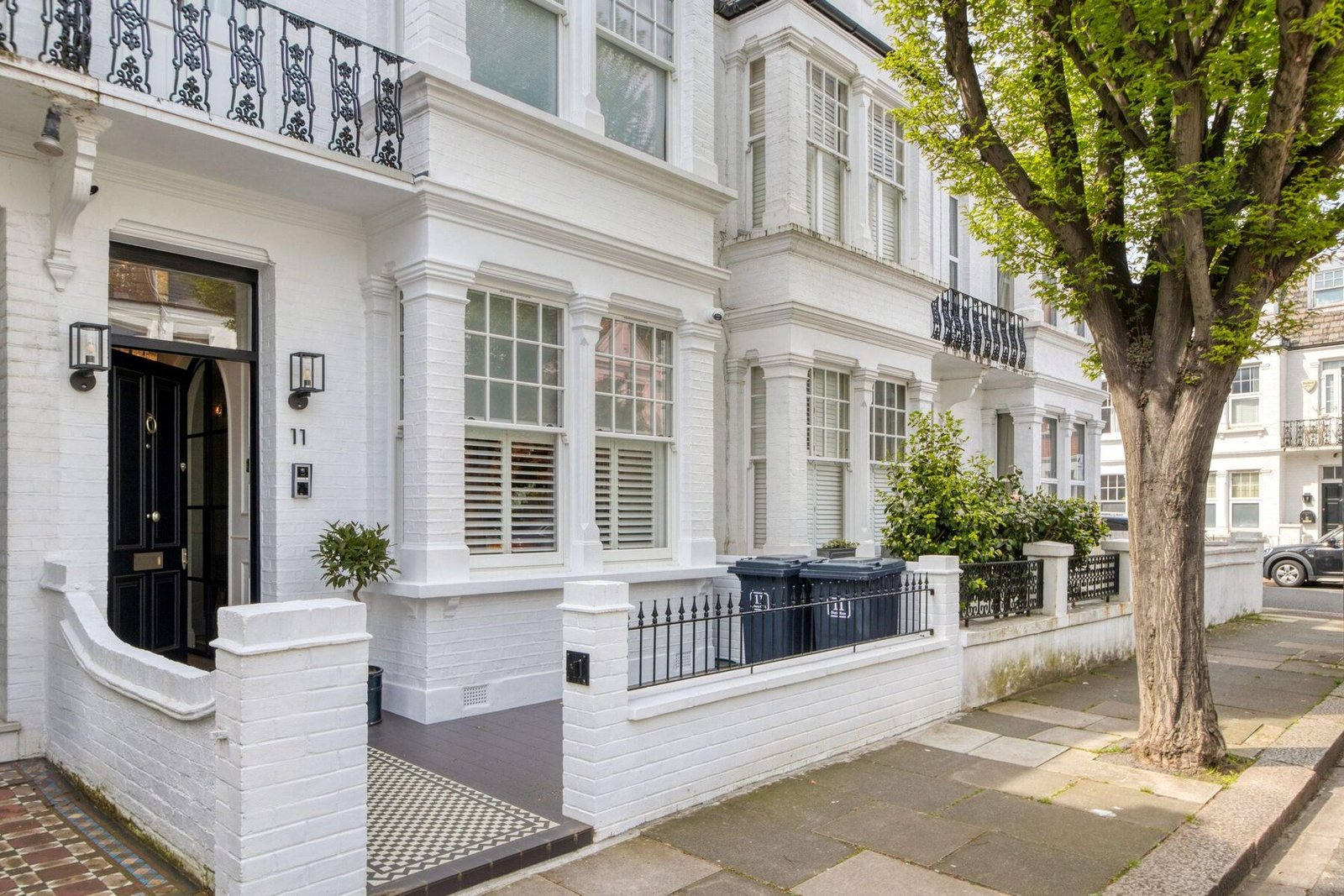 Row of white-painted Victorian terraced houses in London