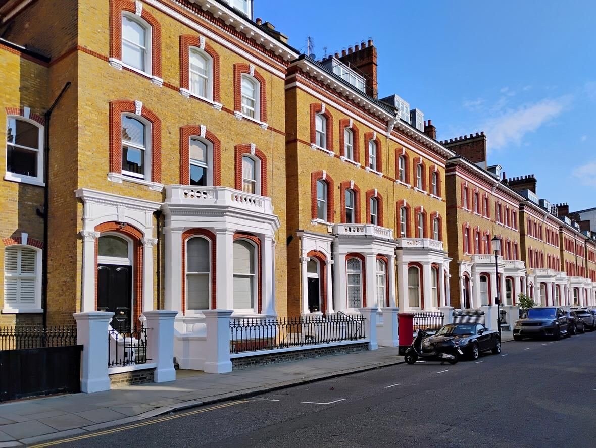 Grand white period townhouse exterior with black railings