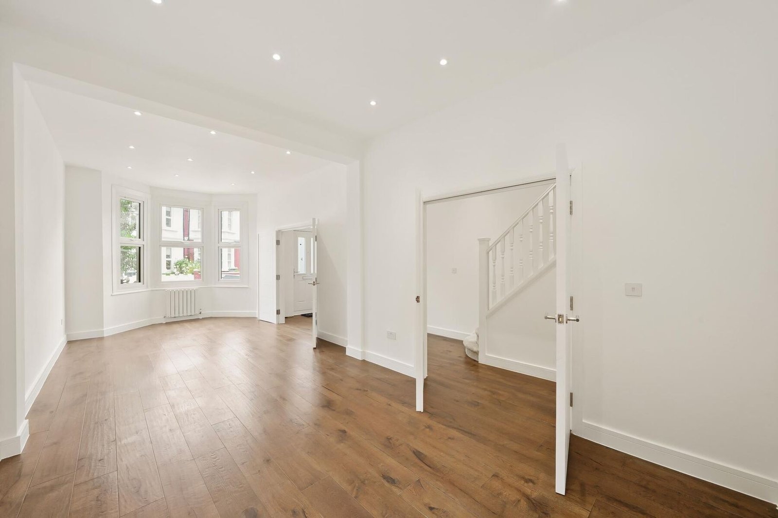Bright period living room with staircase, freshly painted