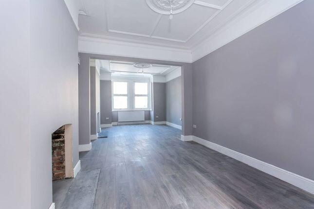 Freshly painted empty room with wood flooring