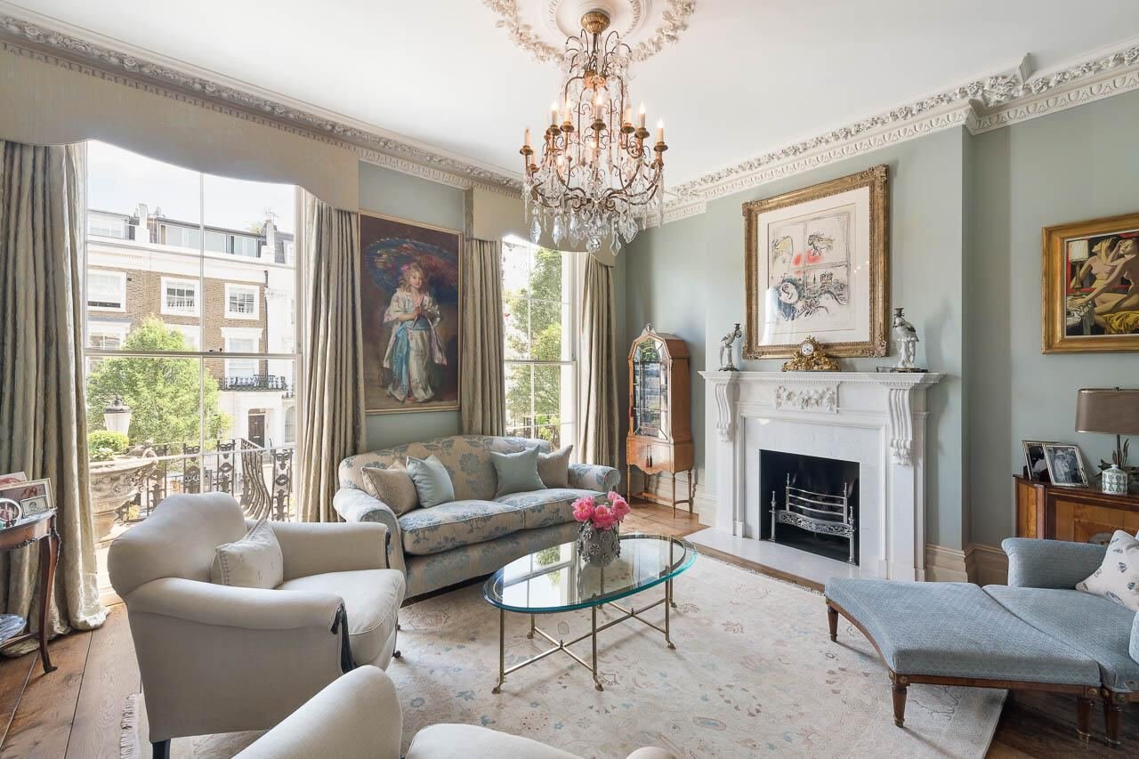 Period living room with chandelier and fireplace, freshly decorated