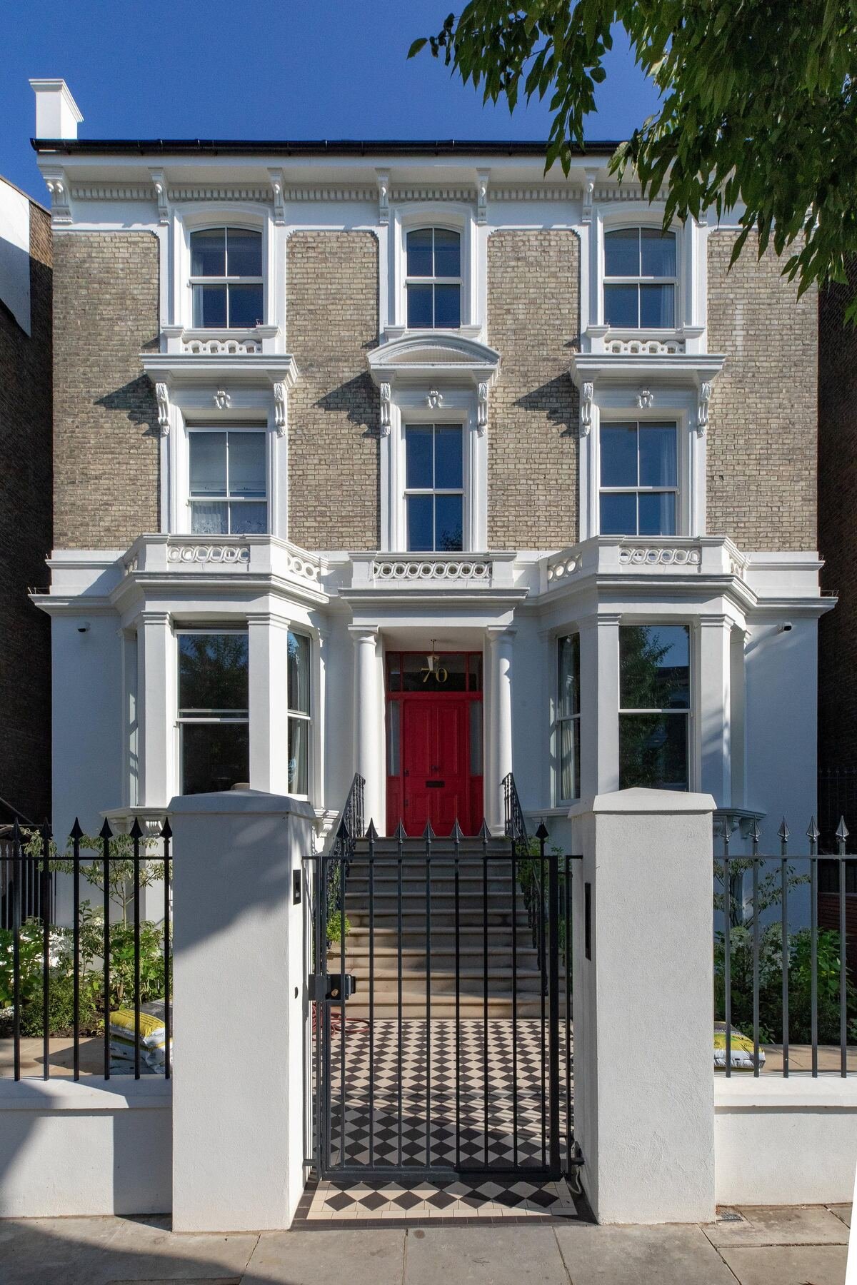London townhouse exterior with red front door